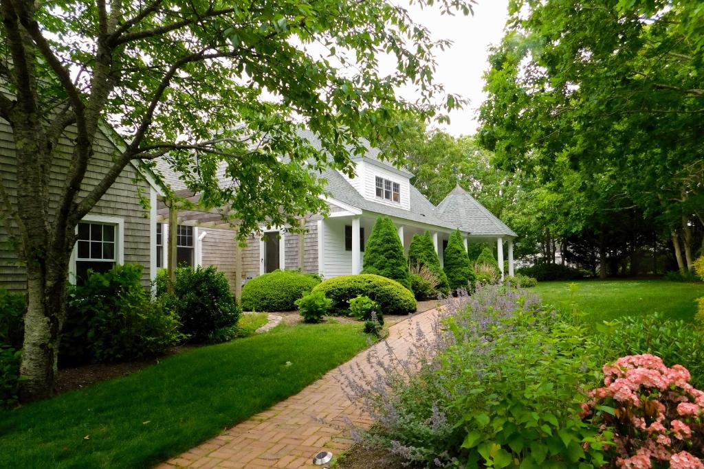 a white house with a brick driveway at Tranquil Haven in West Tisbury