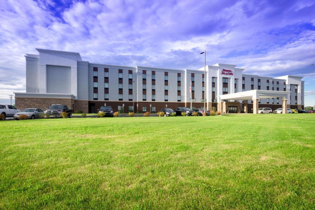 a large building with a green field in front of it at Hampton Inn & Suites By Hilton Hammond, In in Hammond