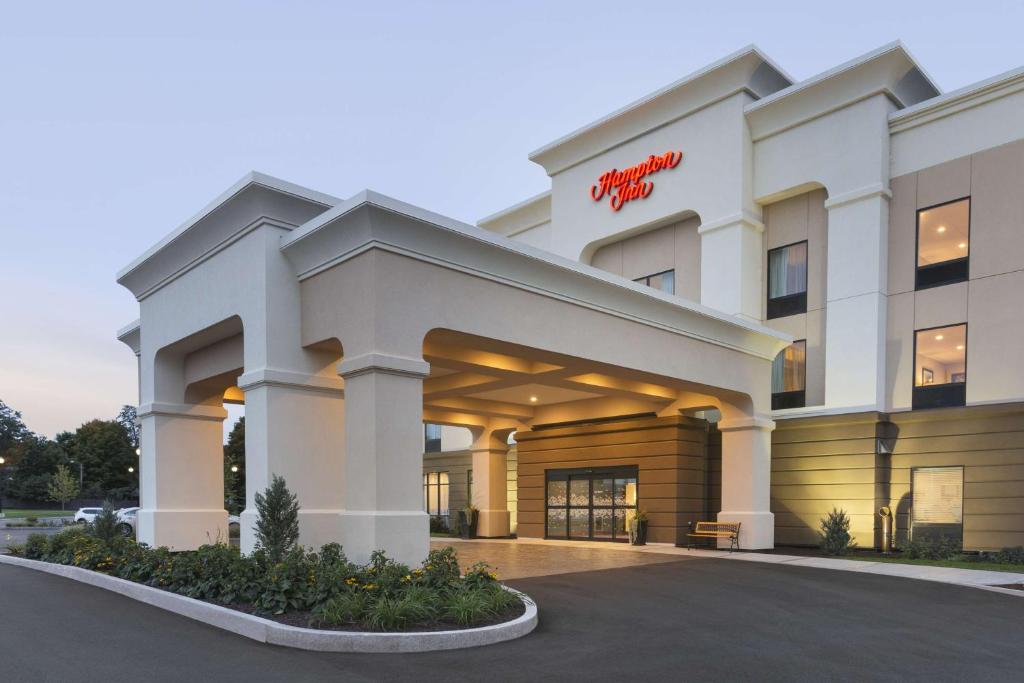 a hotel building with a sign on the front of it at Hampton Inn Penn Yan, NY in Penn Yan