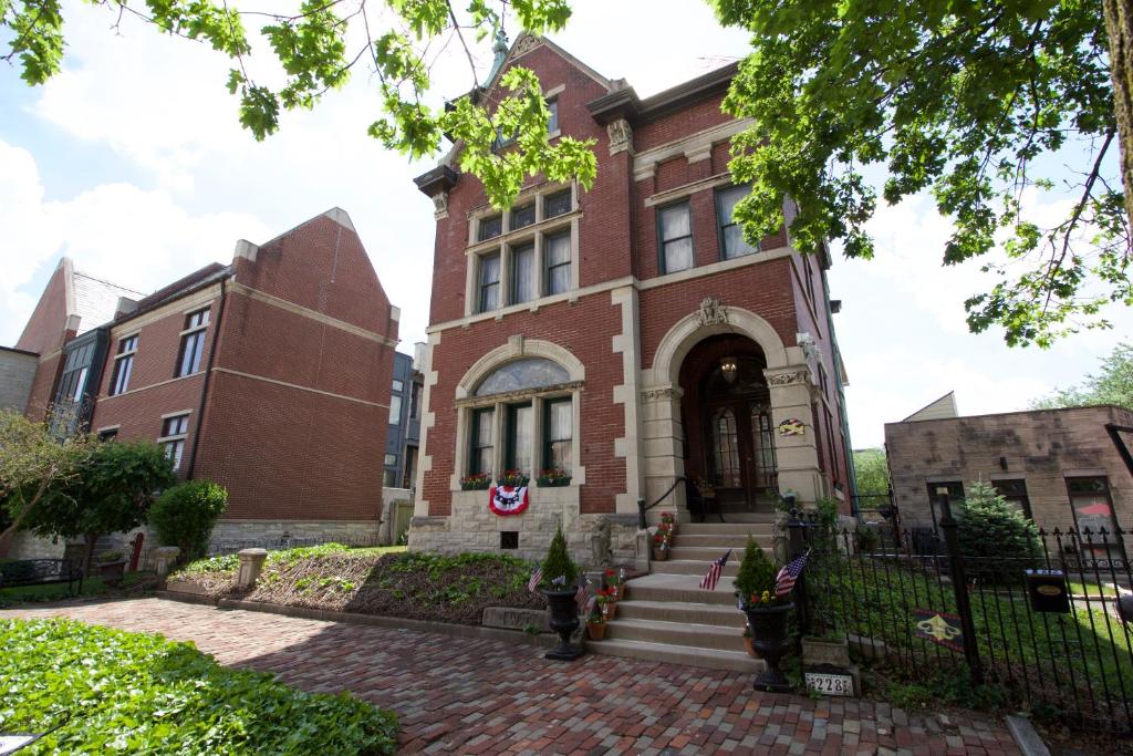 a brick building with a staircase in front of it at Mansion on The Mile B&B in Indianapolis