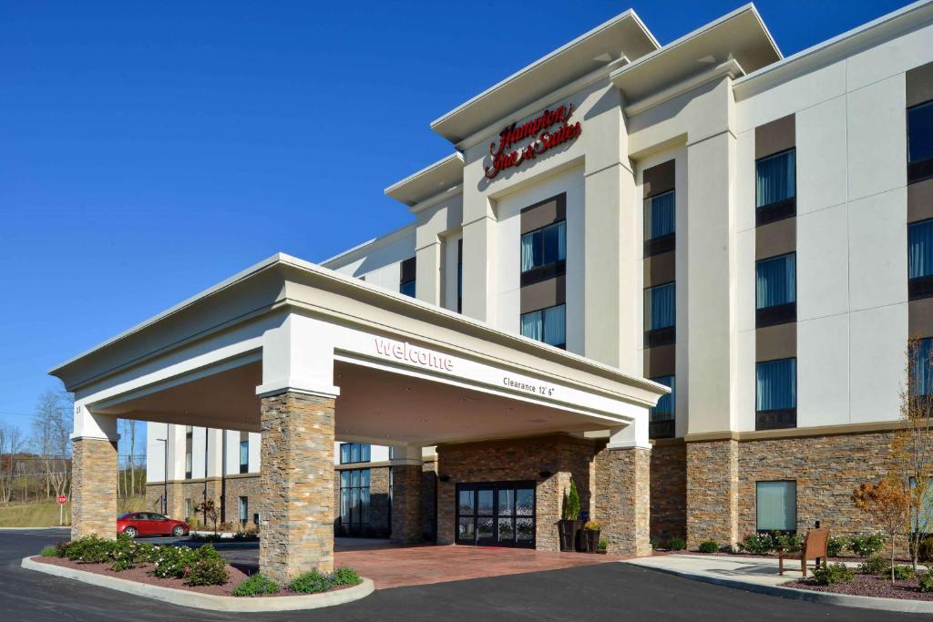 a hotel building with a sign on it at Hampton Inn & Suites Albany-East Greenbush, NY in East Greenbush
