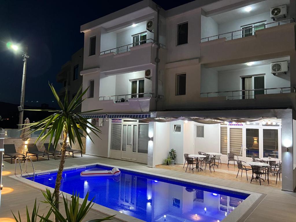 a villa with a swimming pool at night at Apartments Fat e Jet in Ulcinj