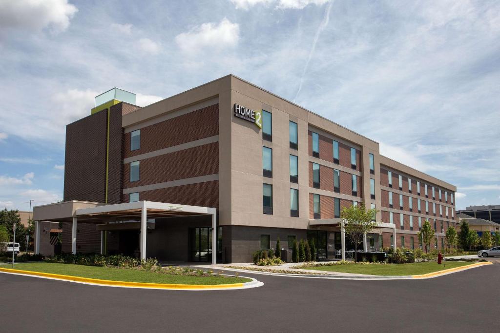 a large building with a hud building at Home2 Suites By Hilton Chicago Schaumburg in Schaumburg