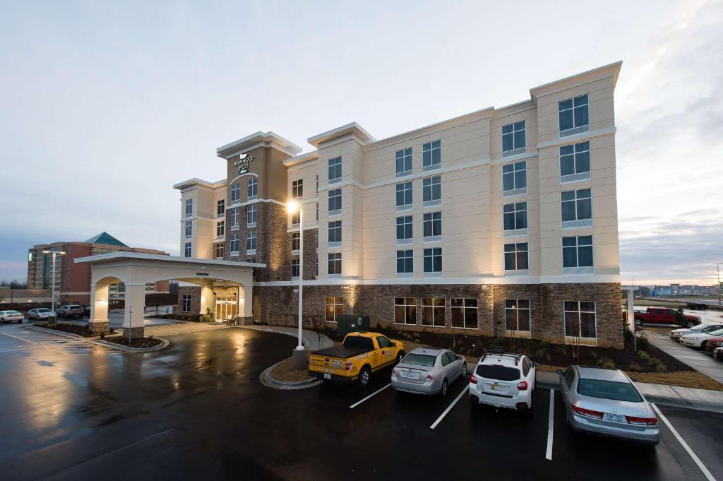 a hotel with cars parked in a parking lot at Homewood Suites by Hilton Concord in Concord