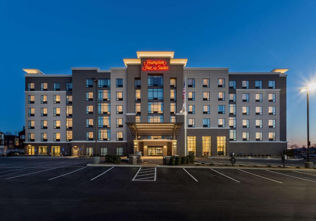 a hotel with a parking lot in front of it at Hampton Inn & Suites Newport/Cincinnati, KY in Newport