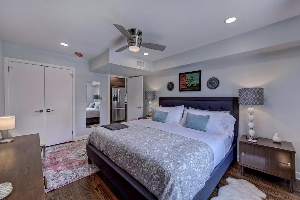 a bedroom with a large bed and a ceiling fan at The Home Collection CLT: 510 Queens in Charlotte