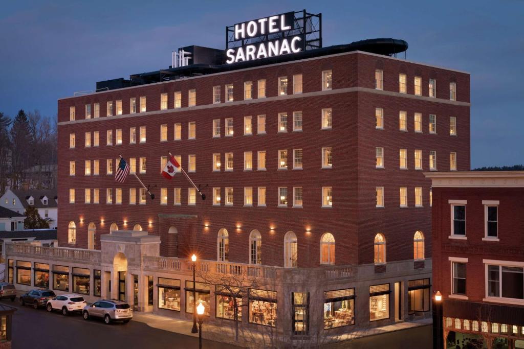 a building with a sign on the top of it at Hotel Saranac, Curio Collection By Hilton in Saranac Lake