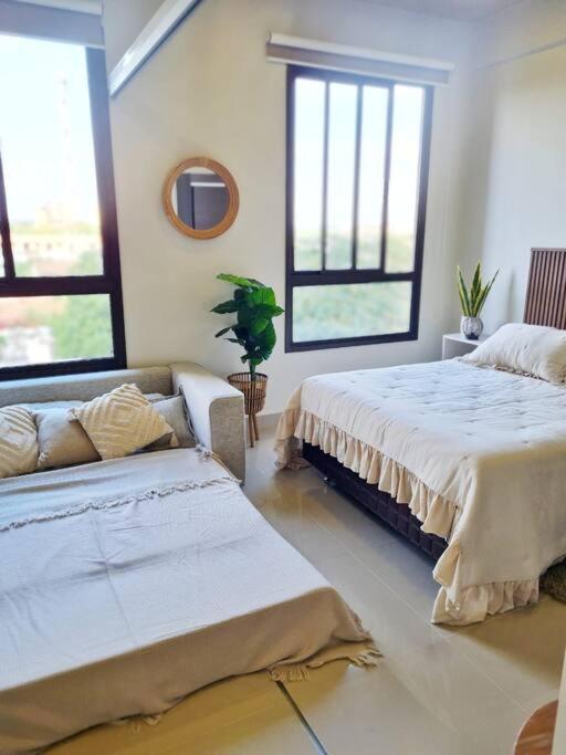 a living room with two beds and a couch at Exclusivo mono para 4 personas in Luque