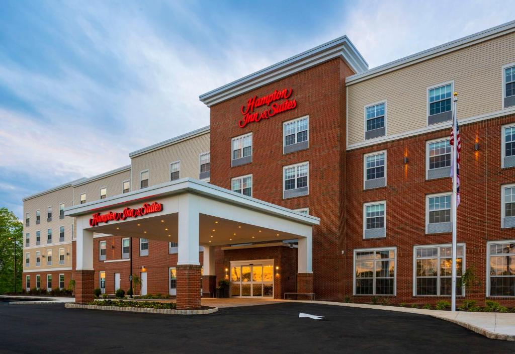 a hotel with a sign on the front of it at Hampton Inn & Suites Bridgewater, NJ in Bridgewater