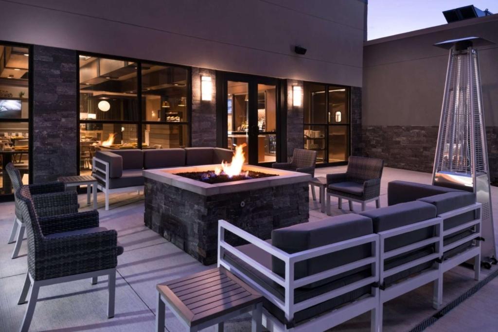 a living room with a fire pit and chairs at Doubletree By Hilton Lafayette East in Lafayette