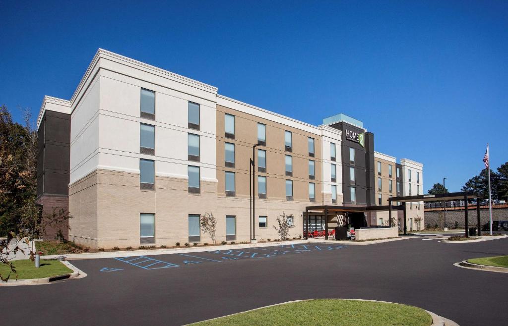 a large white building with a parking lot at Home2 Suites By Hilton Oxford in Oxford