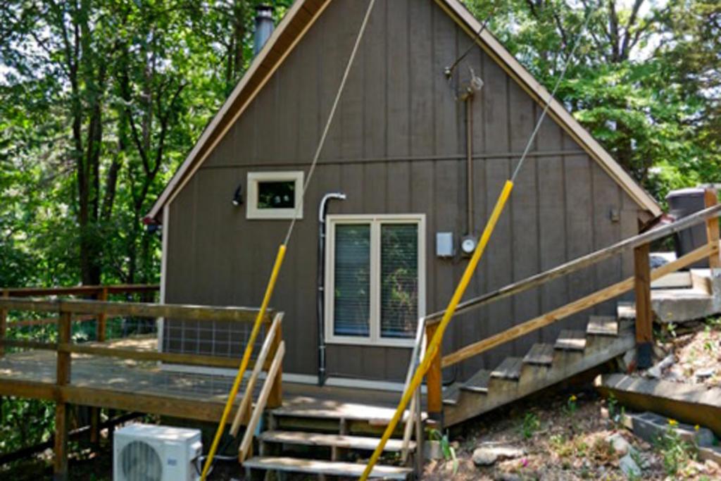 a house with a porch and stairs to the door at Adventure Awaits in Rogers