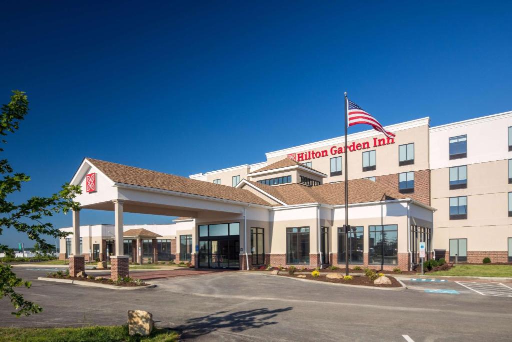 a hotel with an american flag on top of it at Hilton Garden Inn Pittsburgh Airport in Moon Township