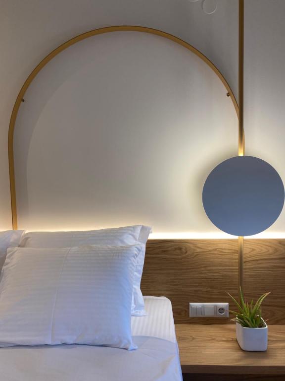 a bedroom with a white bed with a blue lamp at OliVISTA - Live in Nature in Astris