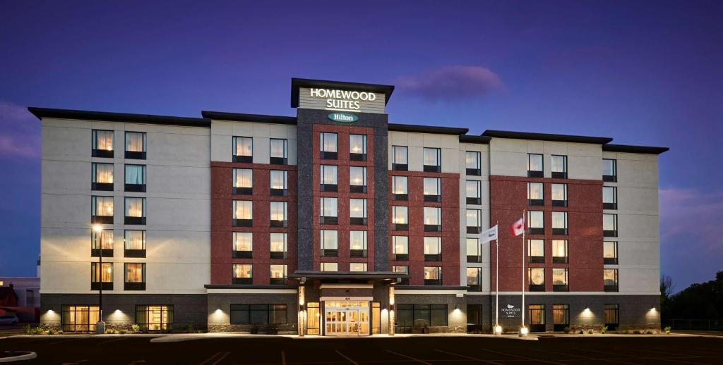 a hotel building with a sign on top of it at Homewood Suites By Hilton North Bay in North Bay