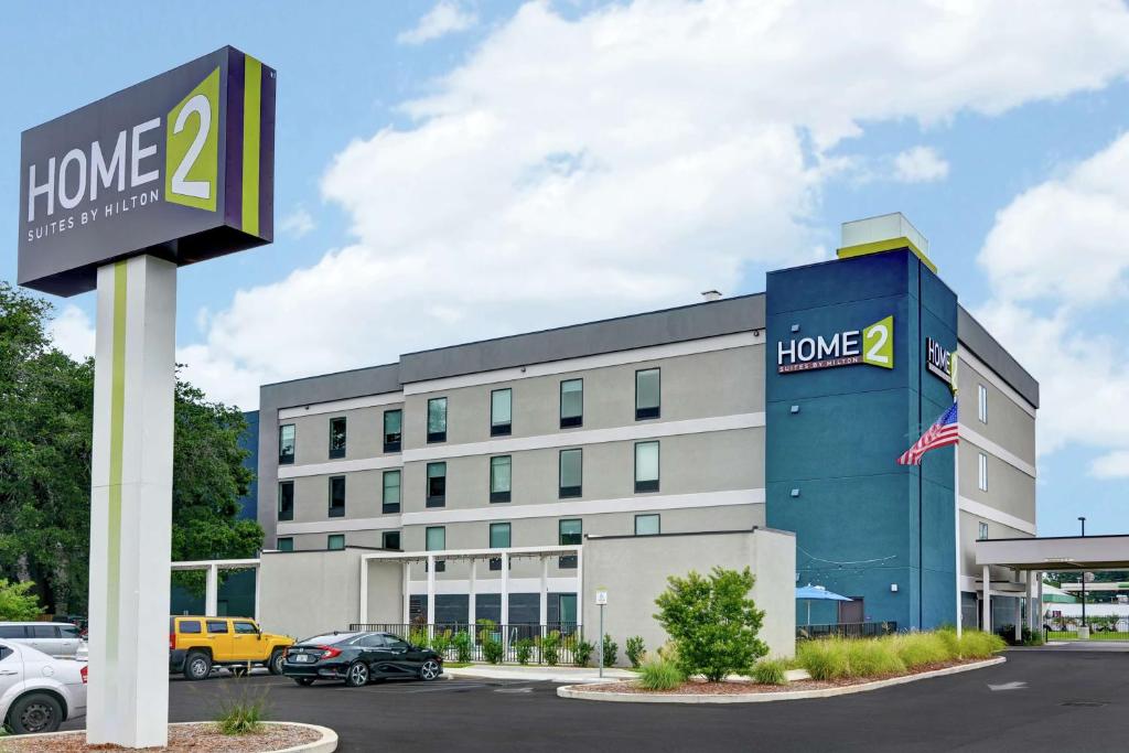 an office building with a home sign in front of it at Home2 Suites Pensacola I-10 At North Davis Hwy in Pensacola