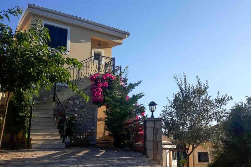 a house with flowers on the side of it at Elena's House in Syvota