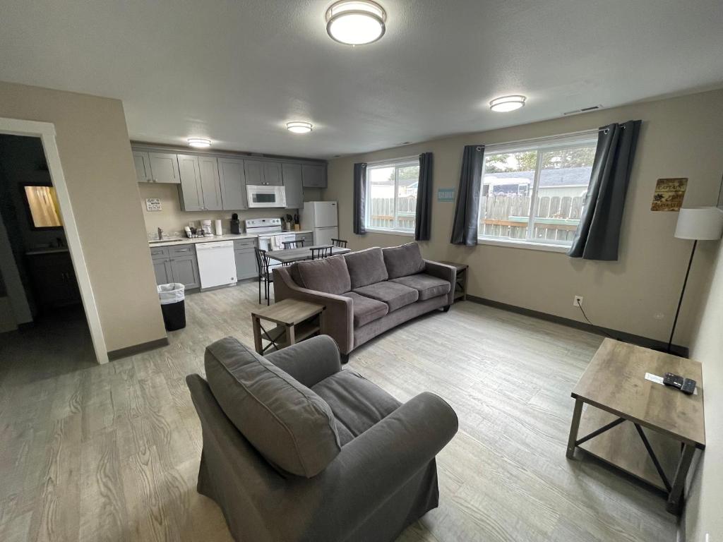 a living room with a couch and a table at Coastal Inn and Suites in Long Beach