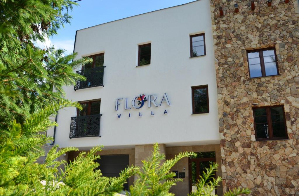 a building with the sign for the floreana villa at FloraVilla in Rajecké Teplice