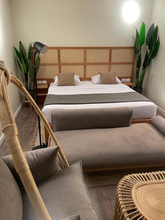 a bedroom with two beds and a chair and a table at Suite 69 in Hurghada