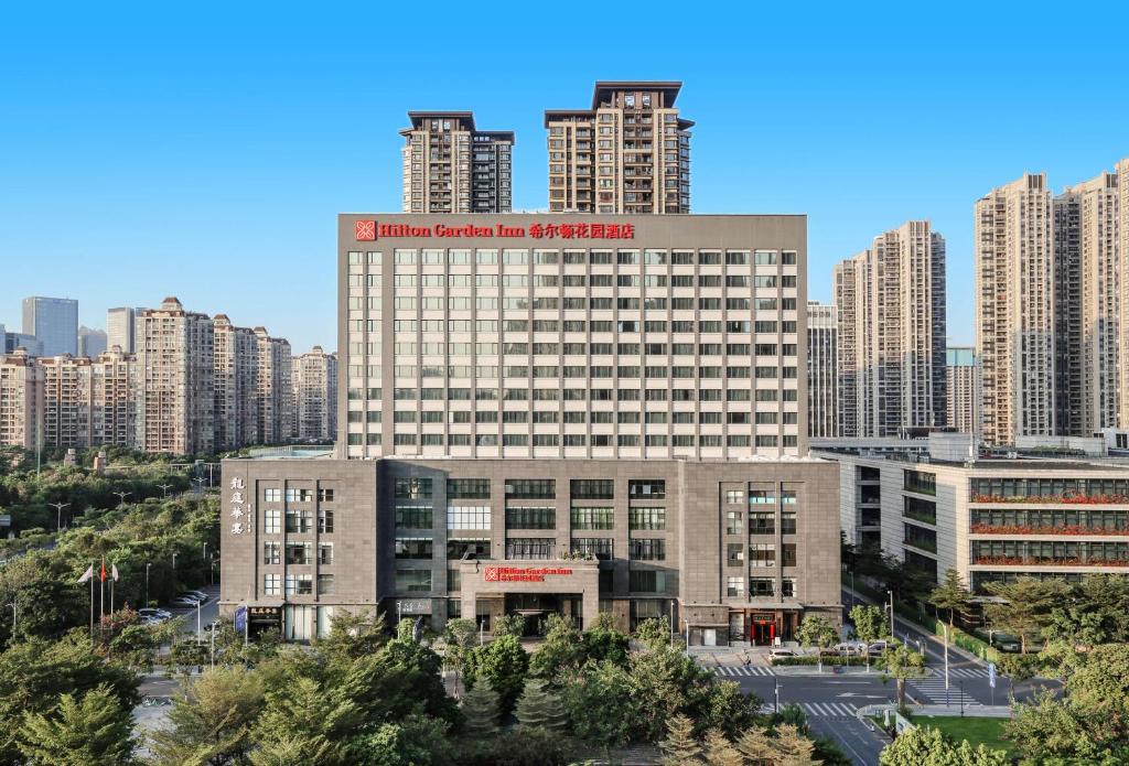 a large building in a city with tall buildings at Hilton Garden Inn Foshan in Foshan