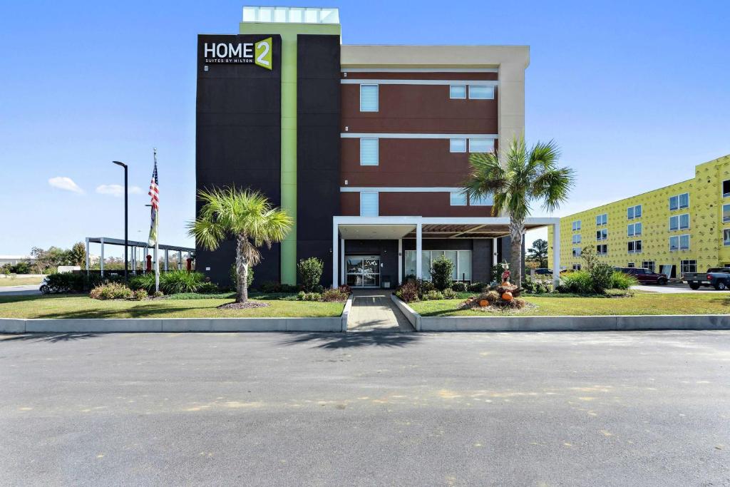 un edificio con un cartel en la parte delantera en Home2 Suites by Hilton Gulfport I-10, en Gulfport