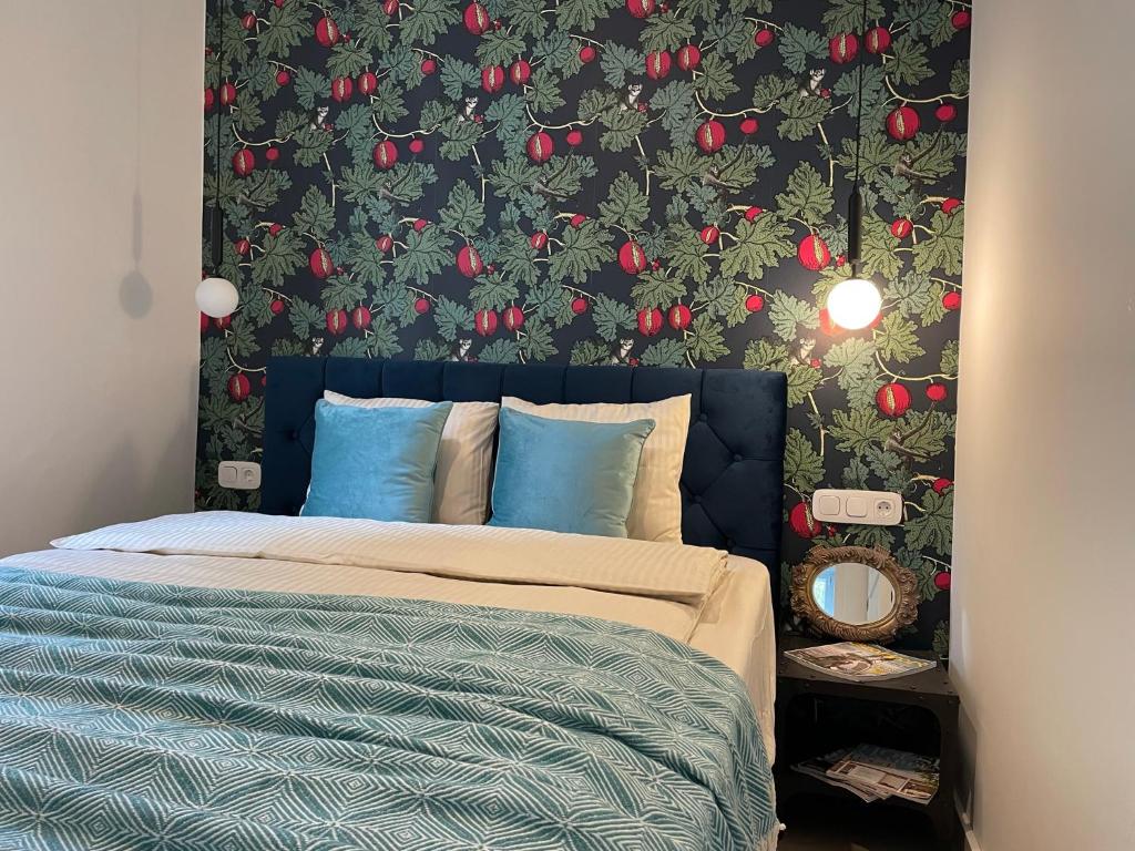 a bedroom with a bed with a wall covered in apples at Number4 in Szeged