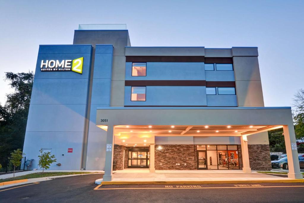 a building with a home improvements sign in front of it at Home2 Suites By Hilton Stafford Quantico in Stafford