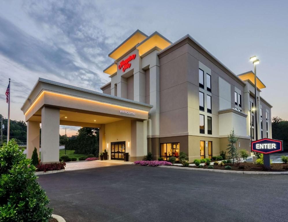 a hotel with a sign in a parking lot at Hampton Inn Covington VA in Covington