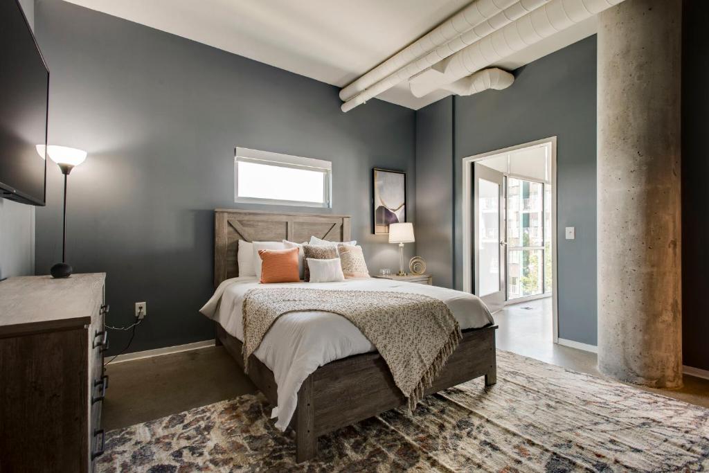 a bedroom with a large bed and a window at Sleek and Spacious Condo In East! in Nashville