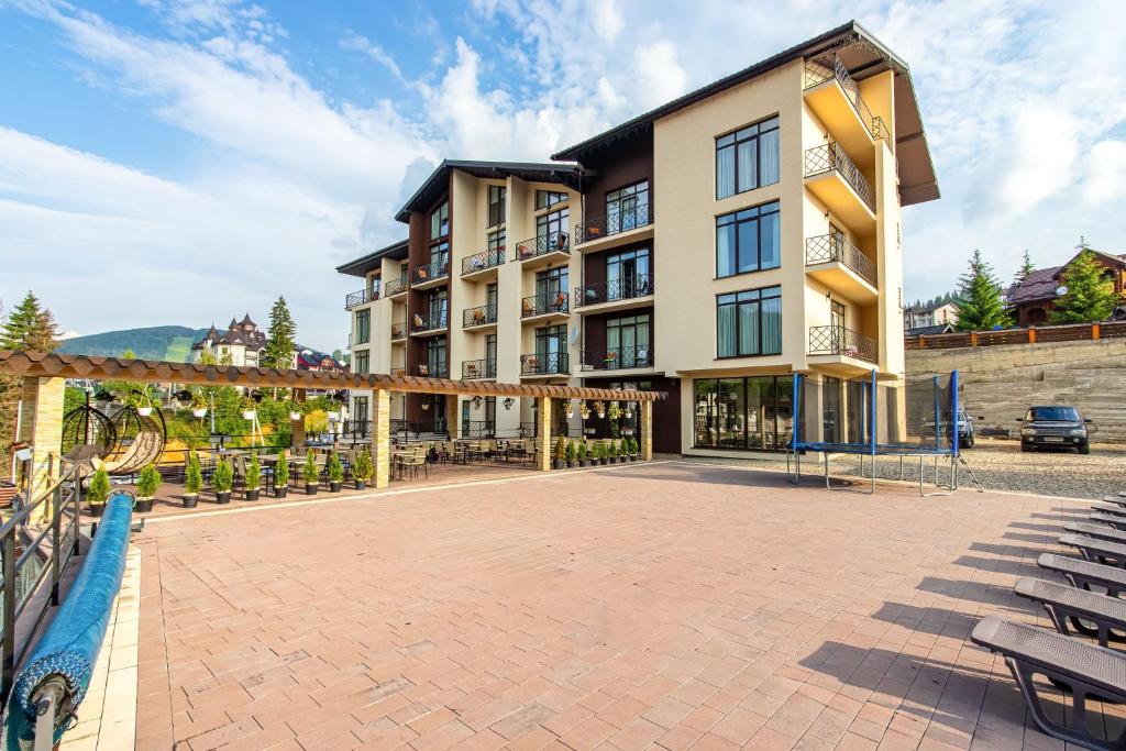 a large building with a patio in front of it at Gold Palace in Bukovel