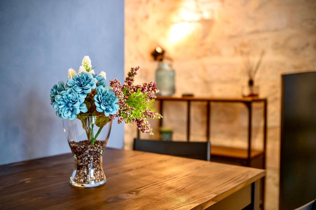 a vase filled with blue flowers sitting on a table at Cà del Centro in Manfredonia
