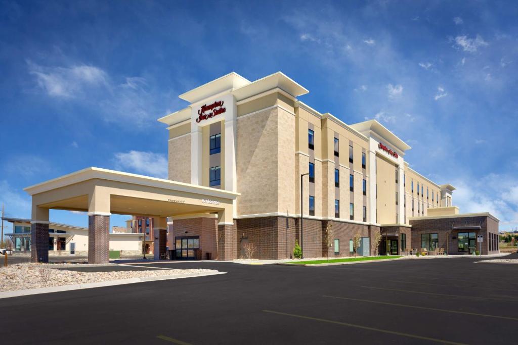 a hotel building with a parking lot in front of it at Hampton Inn & Suites Rexburg in Rexburg