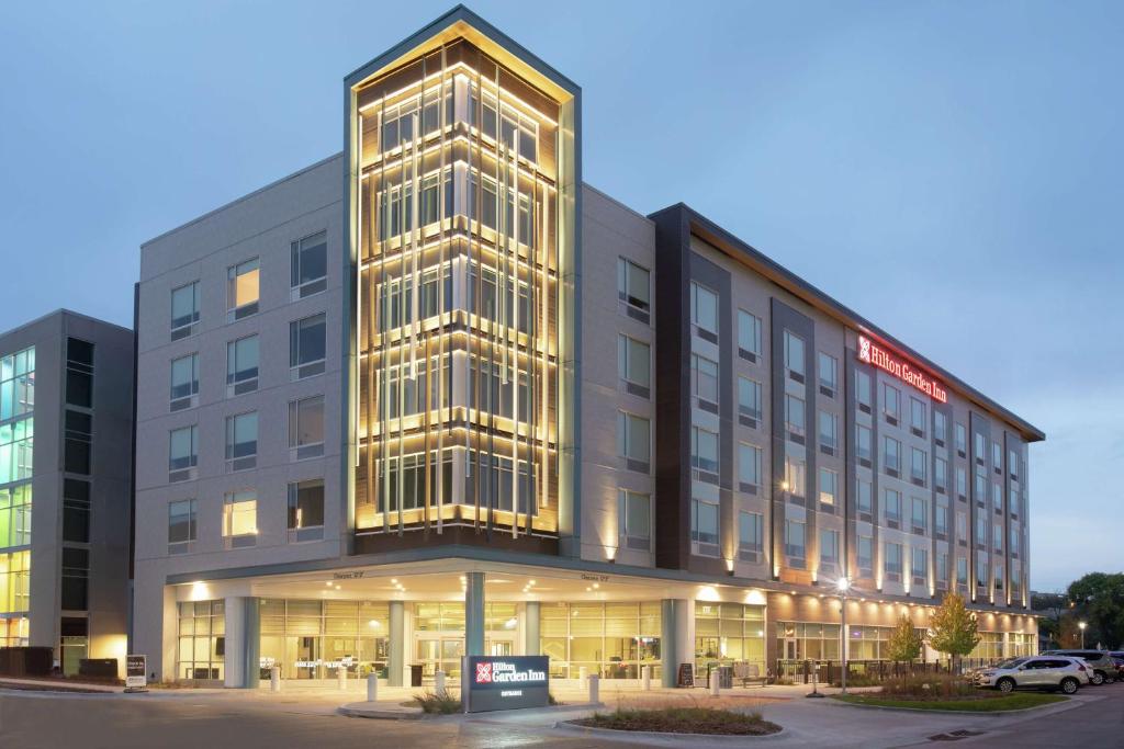 an office building with a lit up facade at Hilton Garden Inn Omaha Aksarben Village in Omaha