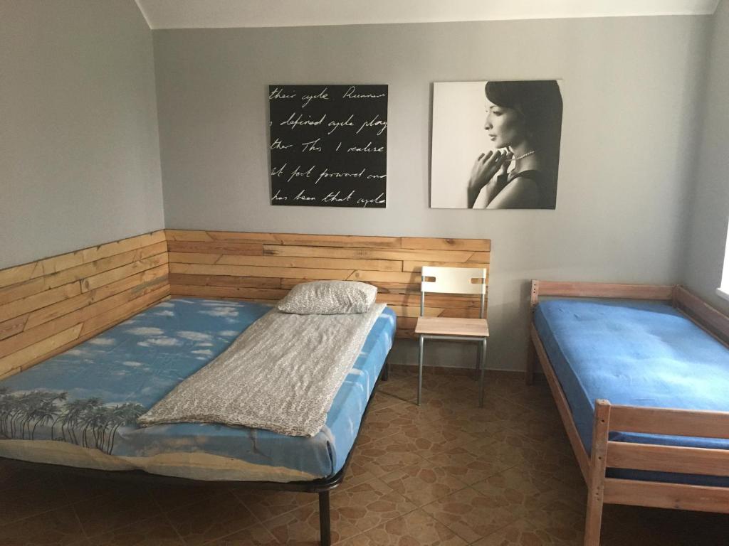 a bedroom with two beds and a chalkboard on the wall at Spokojny nocleg w Centrum in Augustów