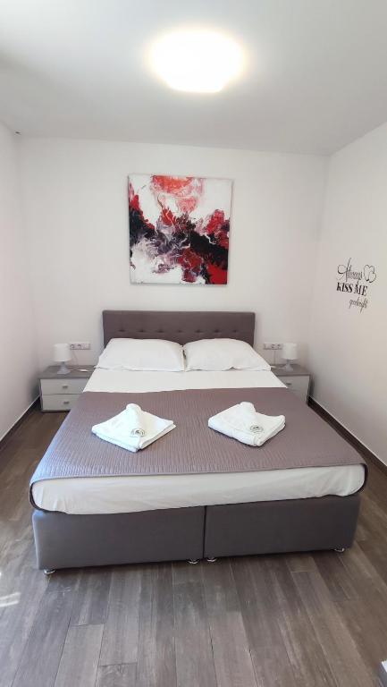 a bedroom with a bed with two towels on it at Holiday Home Aurora in Ližnjan