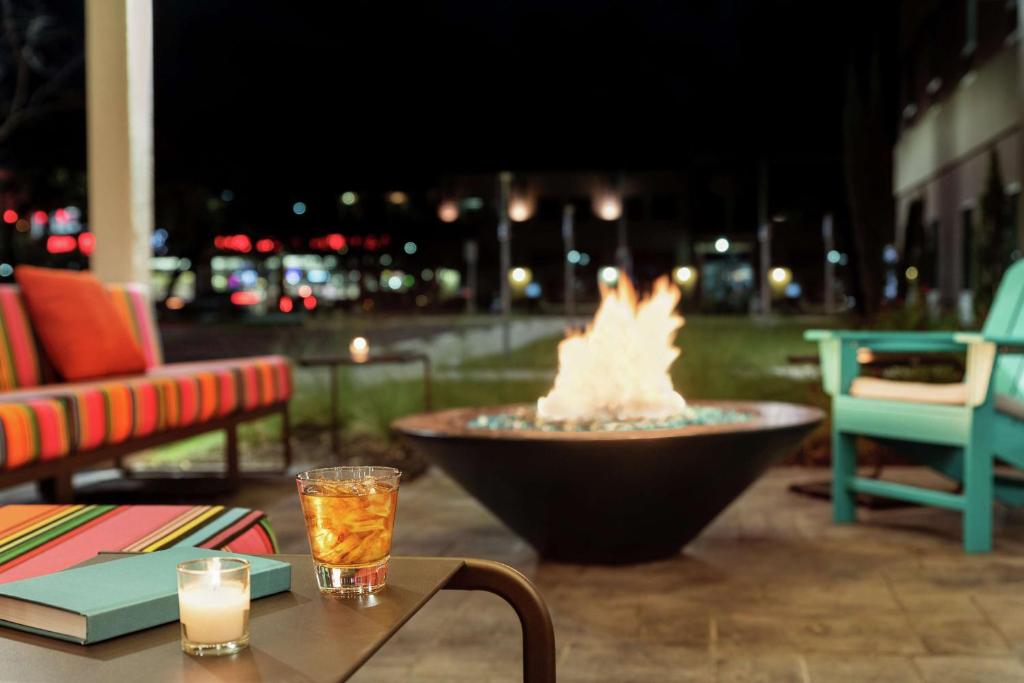 a fire pit sitting on a patio with a table at Home2 Suites By Hilton San Antonio North Stone Oak in San Antonio