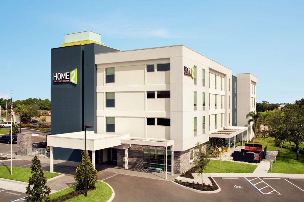 a large white building with a hotel at Home2 Suites By Hilton Sarasota Bradenton Airport in Sarasota