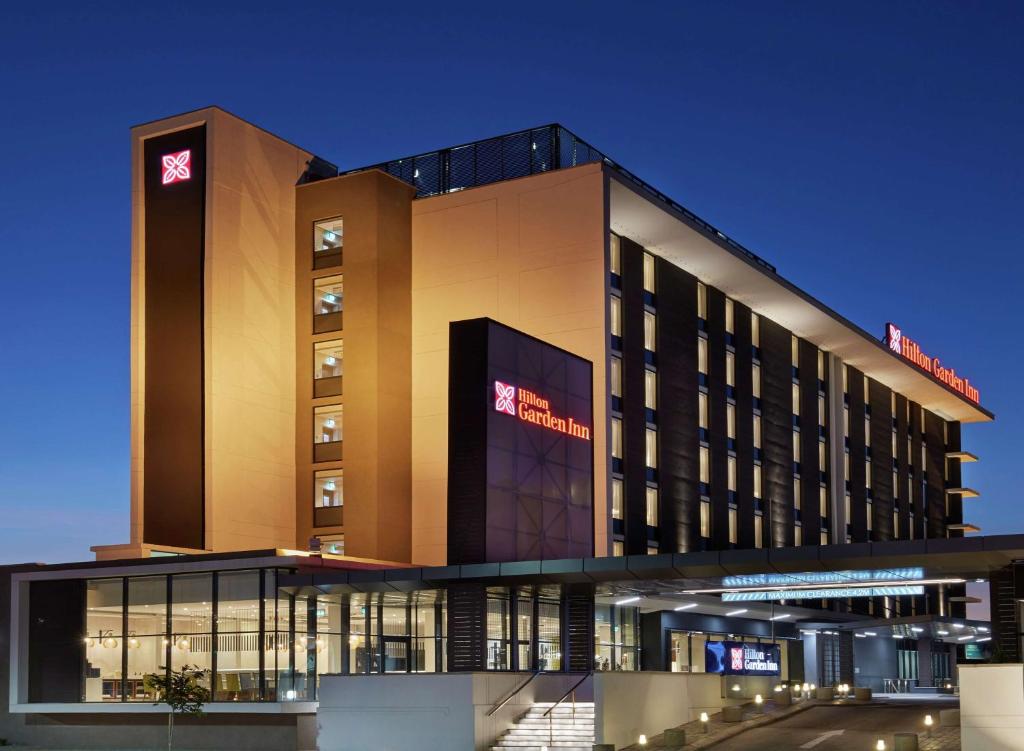 a hotel building with a sign on top of it at Hilton Garden Inn Gaborone, Botswana in Gaborone