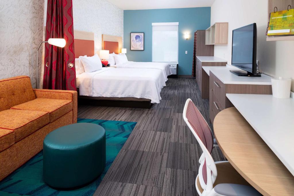 a hotel room with a bed and a tv at Home2 Suites By Hilton Charlotte Mooresville, Nc in Mooresville