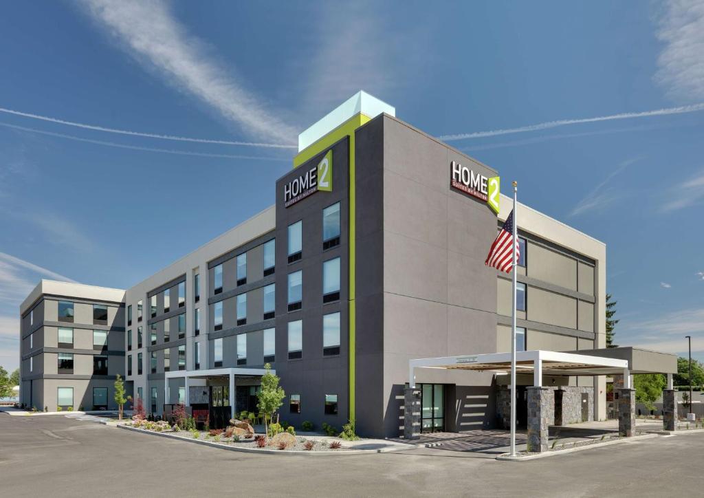 a rendering of a hotel building with an american flag at Home2 Suites By Hilton Yakima Airport in Yakima