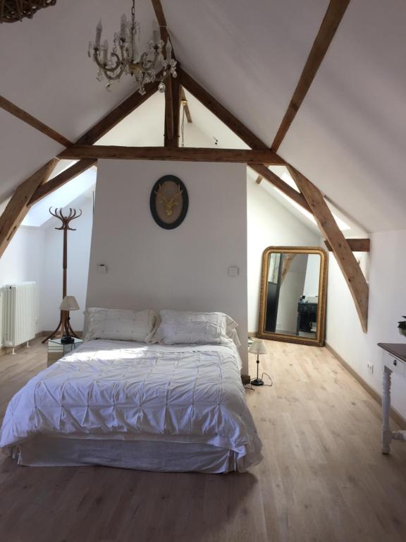 a bedroom with a large bed in a attic at 2 DESCARTES in La Flèche