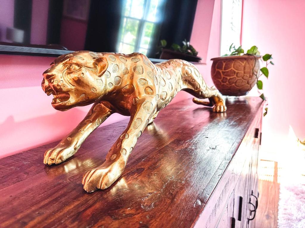 a statue of a dog sitting on top of a table at Dreaming With Dolly - Luxe Stay Near Broadway in Nashville
