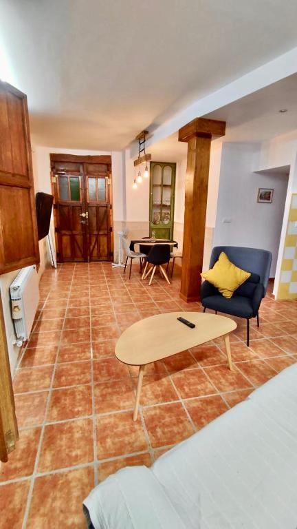 a living room with a couch and a table at Casa rural Almazara in Letur