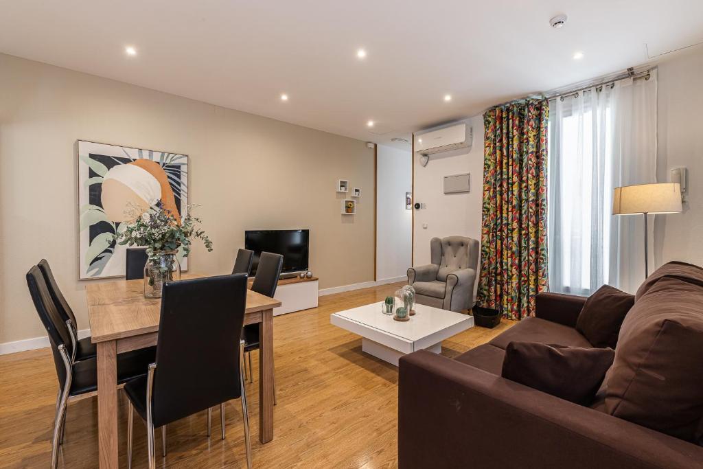 a living room with a couch and a table at BNBHolder Apartamentos en Sol Confort 5 in Madrid