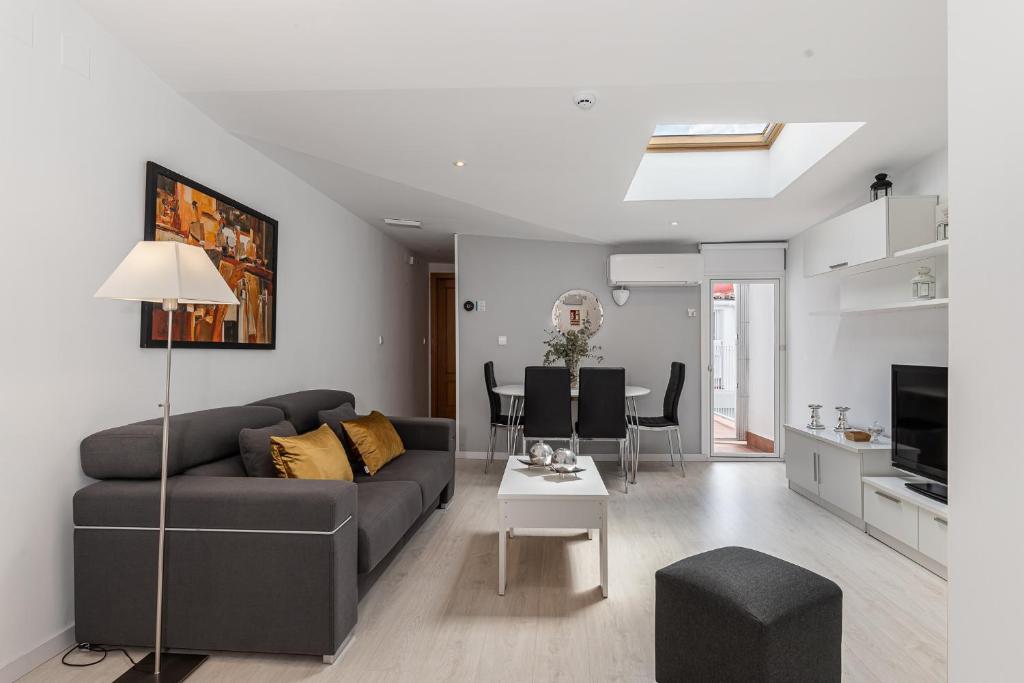 a living room with a couch and a table at BNBHolder Apartamentos en Sol Confort 1 in Madrid