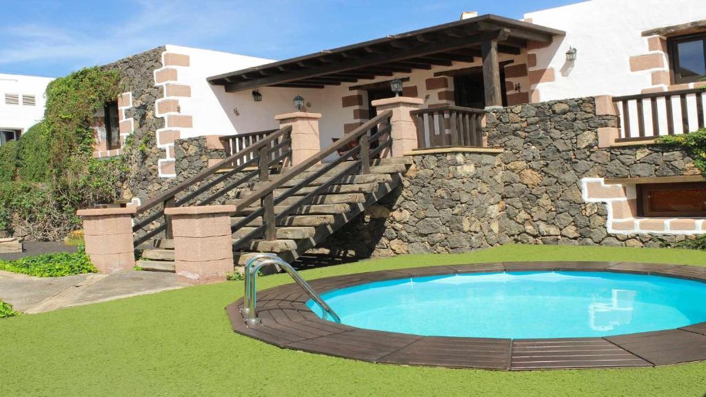a swimming pool in front of a house at Casa Daniela en la Asomada in La Asomada