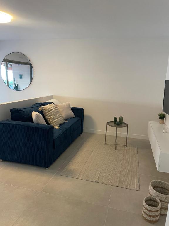 a living room with a blue couch and a table at Juan les pins in Antibes