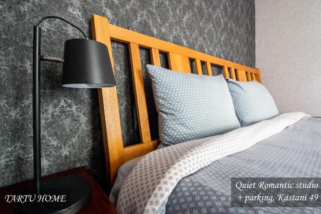 a bedroom with a bed and a black lamp at Quiet Romantic Studio plus parking, Tartu Home in Tartu