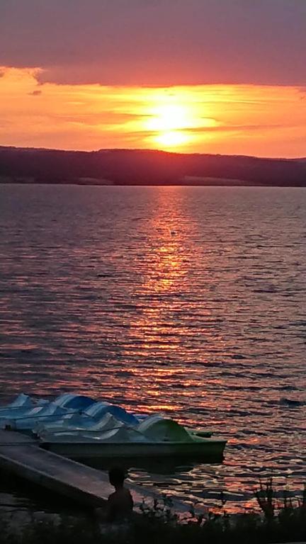 a boat on the water with a sunset in the background at Gite Le petit Nice in Pradelles